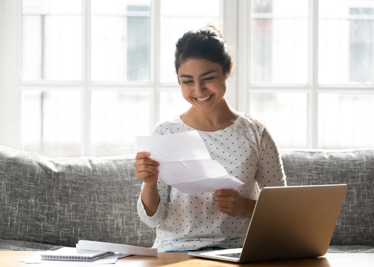 A student reading over an application essay with a laptop